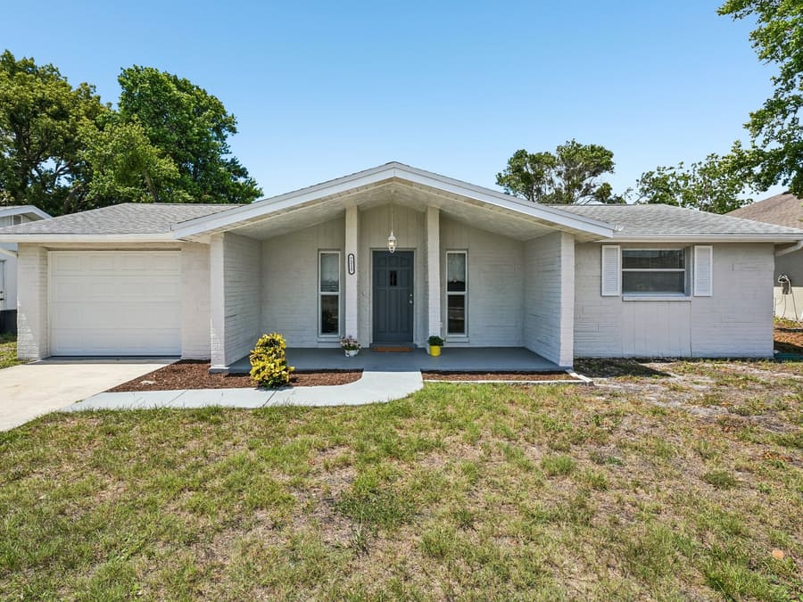 Front exterior with fresh landscaping at 7215 Mayfield Dr, Port Richey